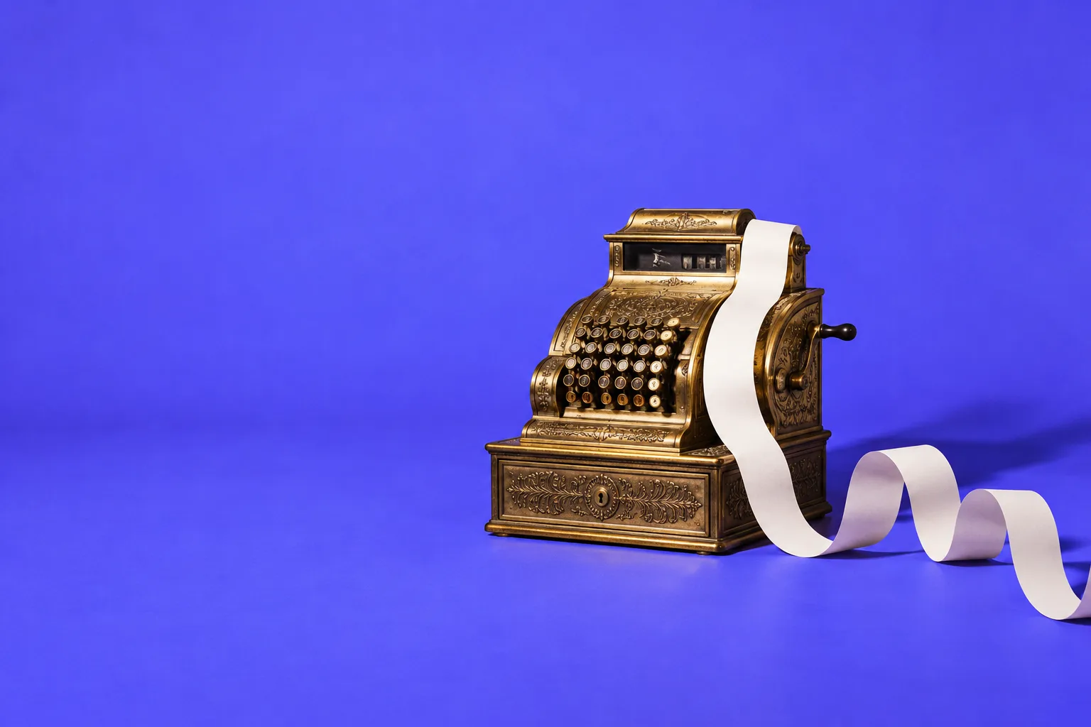 A brass cash register with its paper receipt streaming out in one long ribbon across a blurple floor