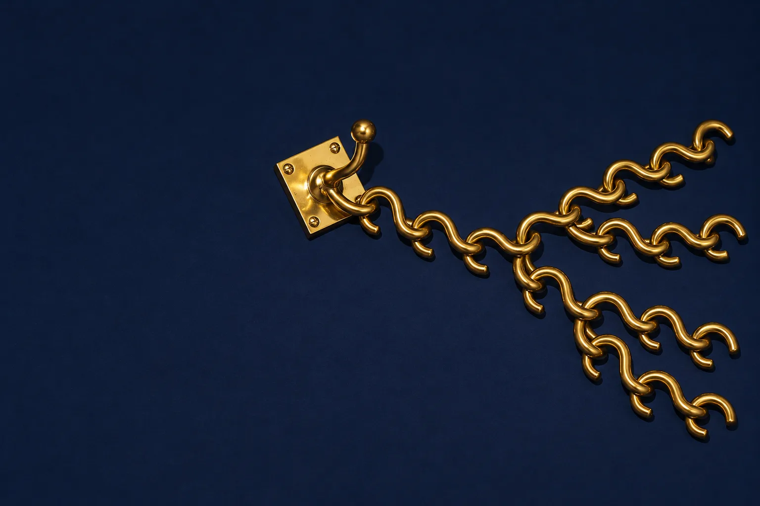 A brass hook with a chain of S-hooks that branches into four chains across a navy floor