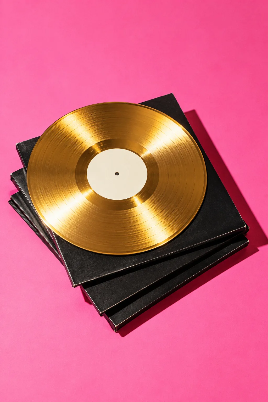 A gold record on a stack of black vinyl sleeves, for Ditto Music