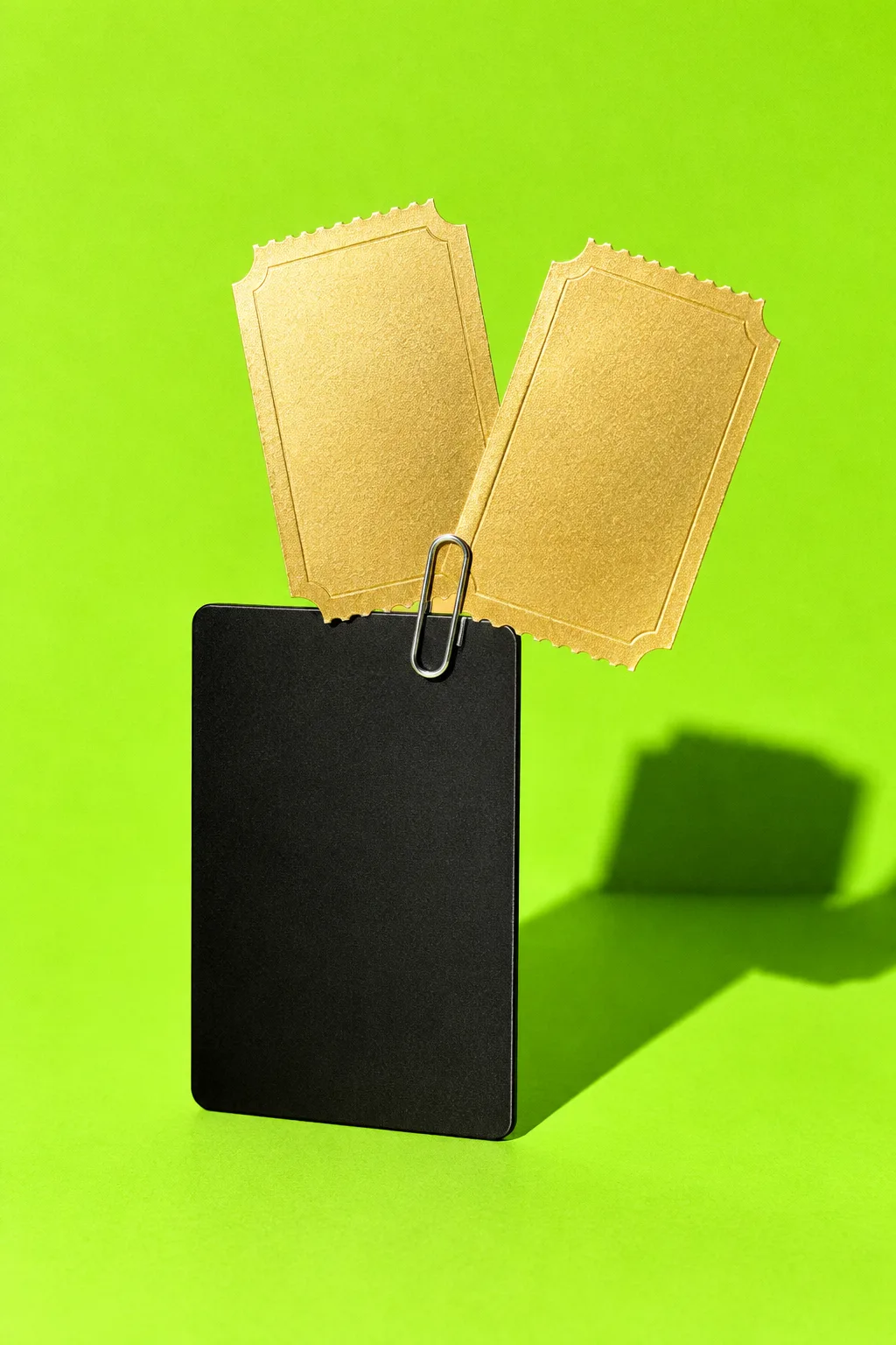 Two gold prize tickets clipped to a black card, for Tap